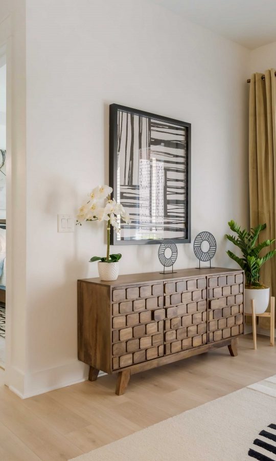 a living room with a large window and a door at The Allure