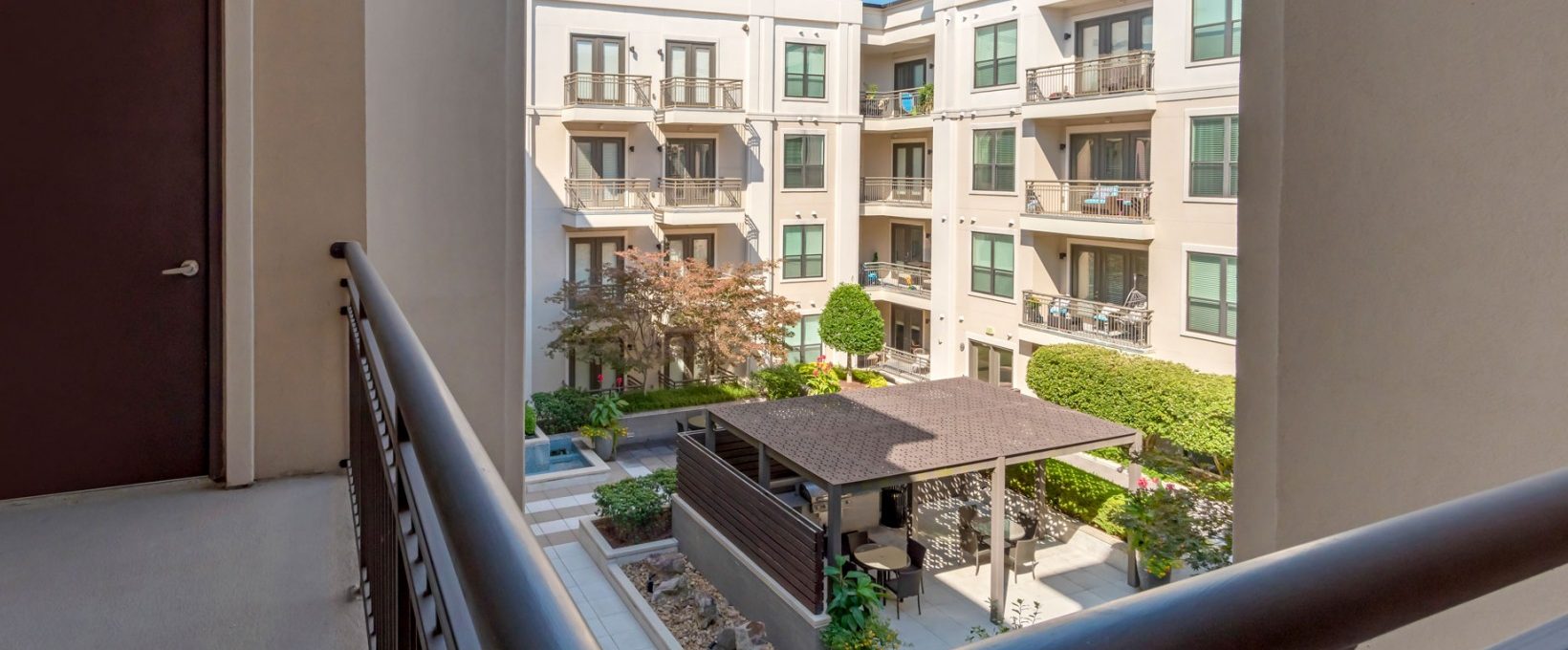 balcony view of apartment complex with patio and pool at The Allure