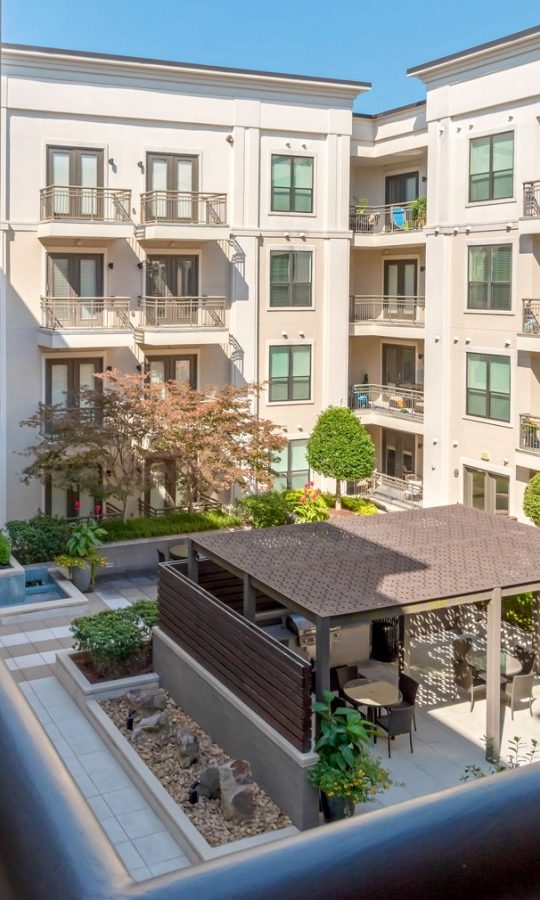 balcony view of apartment complex with patio and pool at The Allure