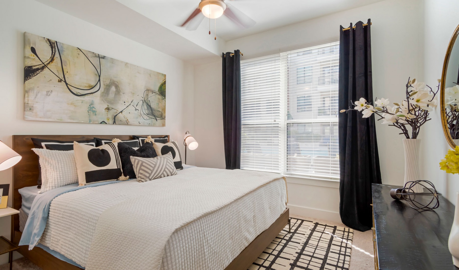 a bedroom with a large bed and a large window at The Allure